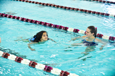 Nine-year-old Reilly Lindsey (left) used to be terrified of the water – now she loves to swim – thanks to a program initiated by Phi Epsilon Kappa that partners University students with children training for the Special Olympics. Occupational therapy major Chloe Scobee ’13 trains with Lindsey in the Byron Recreation Complex.